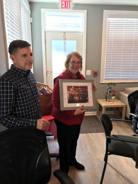 Ken Barton presenting Dottie Samonisky the framed and signed group photo from her retirement party. Photo credit: Bill Dennison.