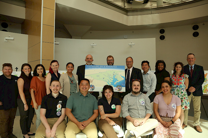 A group image of Chesapeake Report Card cover poster and UMCES and Integration and Application Network staff, interns, fellows, and scholars. Photo by Nathan Miller.