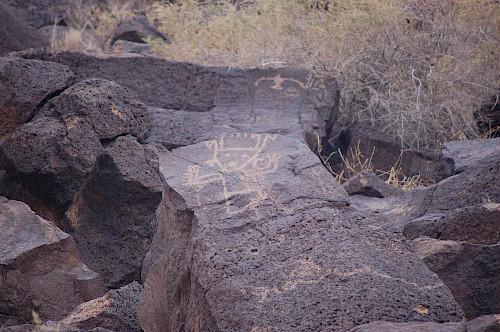 Petroglyph of a dancing person at Petroglyph National Monument in Albuquerque, NM