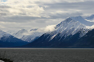The drive along Seward Highway from Anchorage, Alaska features views of the Kenai Mountains and Turnagain Arm waterway.