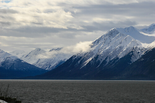 The drive along Seward Highway from Anchorage, Alaska features views of the Kenai Mountains and Turnagain Arm waterway.