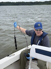Brady Bayne collecting water quality data.
