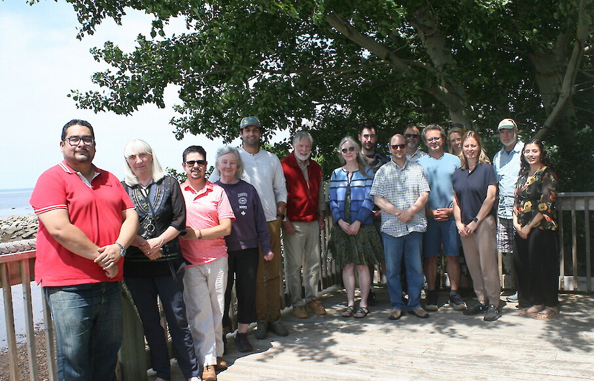 A group photo of the workshop attendees standing side by side outside.