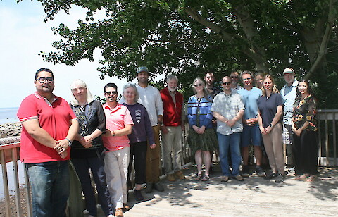A group photo of the workshop attendees standing side by side outside.